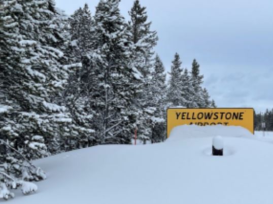 Snow piled high next to the Yellowstone Airport sign